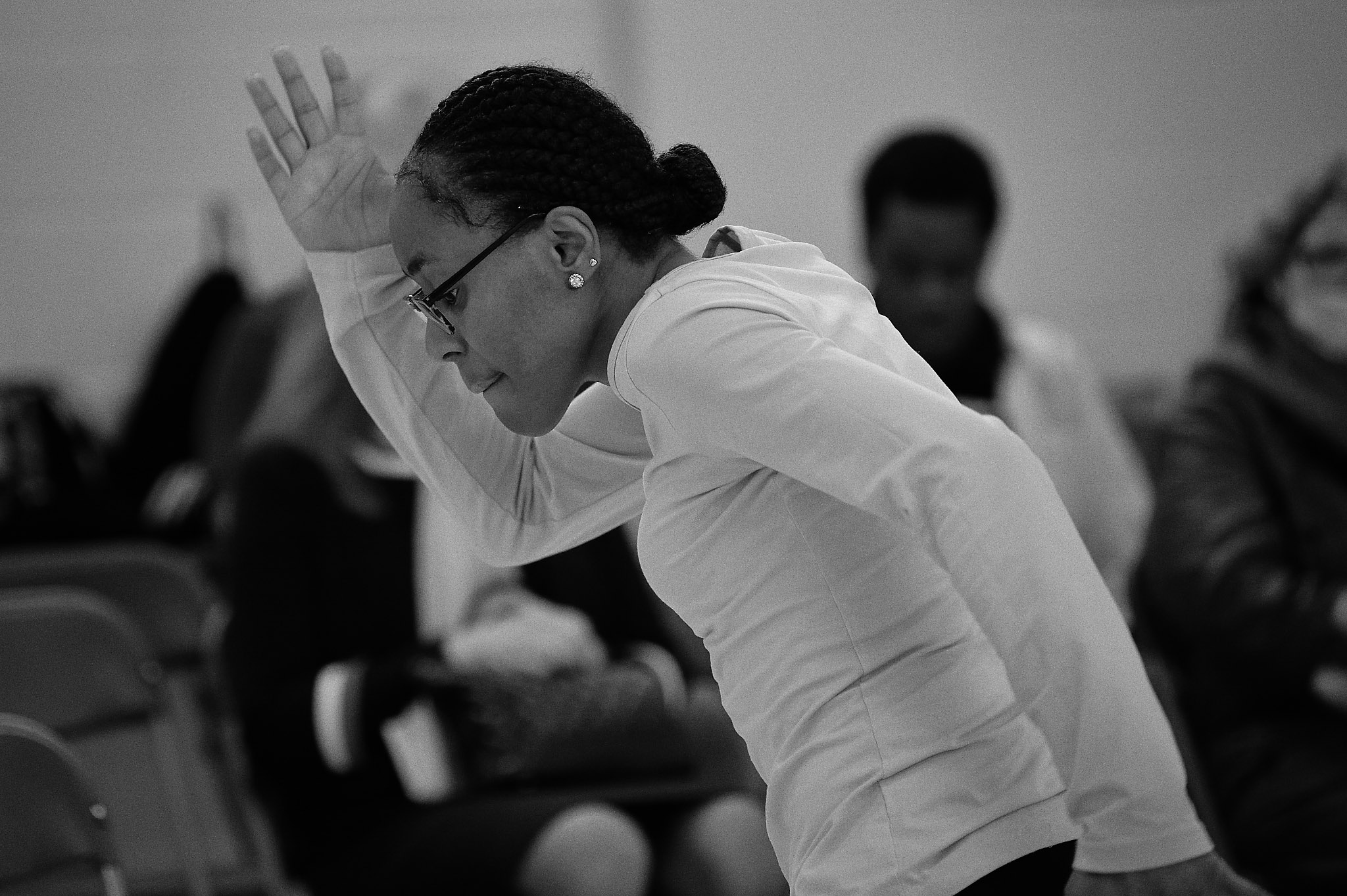 Black and white photo of Nicole dancing at Professional Development Class sharing